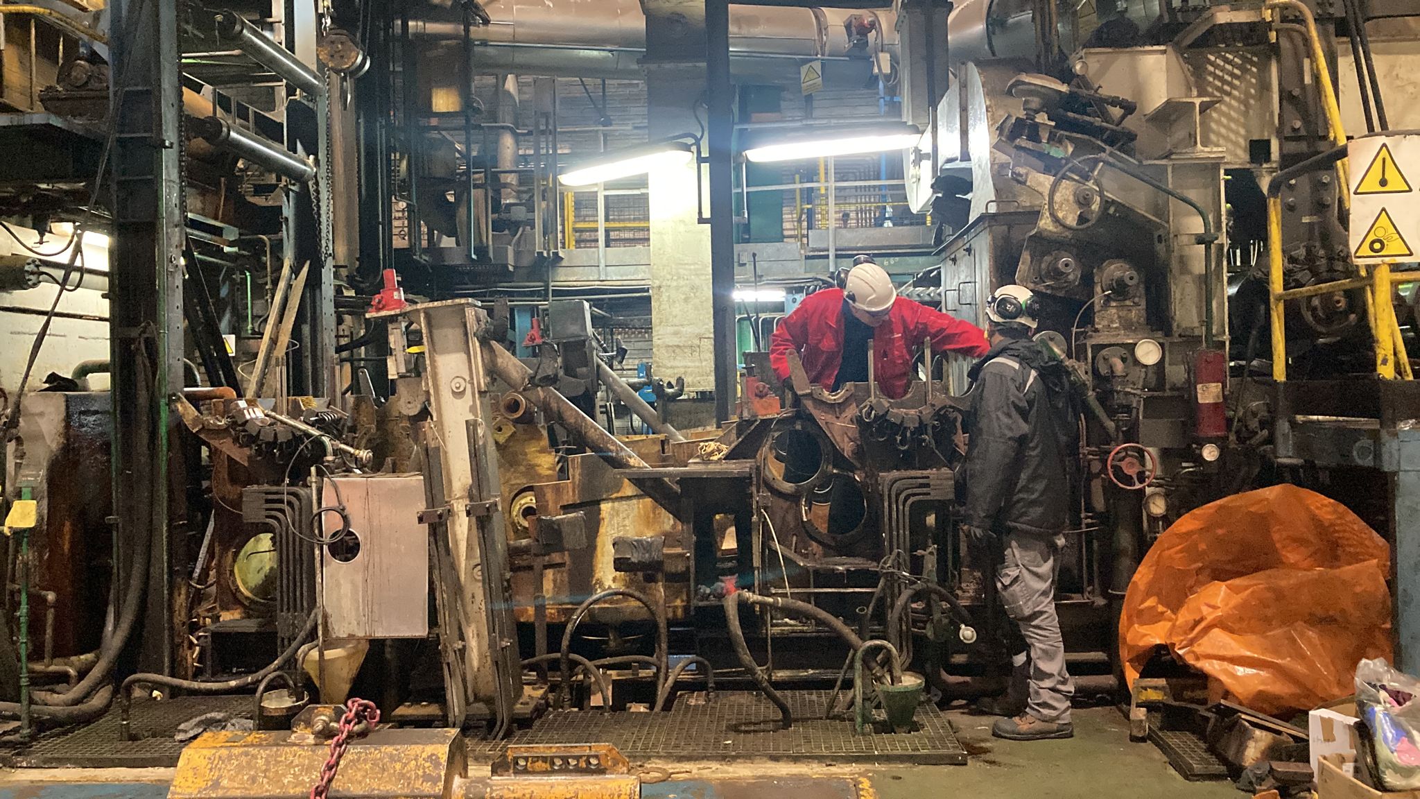 Figure 2: Technicians performing maintenance on industrial machinery during scheduled downtime.