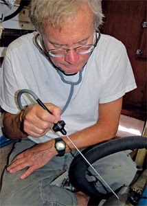 Figure 22: Stethoscope inspection to detect abnormal noise in boat engine. Source: BoatUS