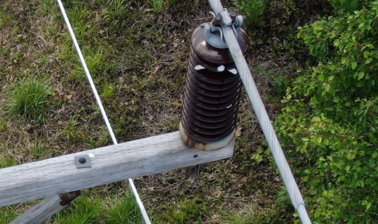 Figure 6: Broken electrical insulation and damaged conductor. Photo taken with drone. Source: AUI Power Blog.