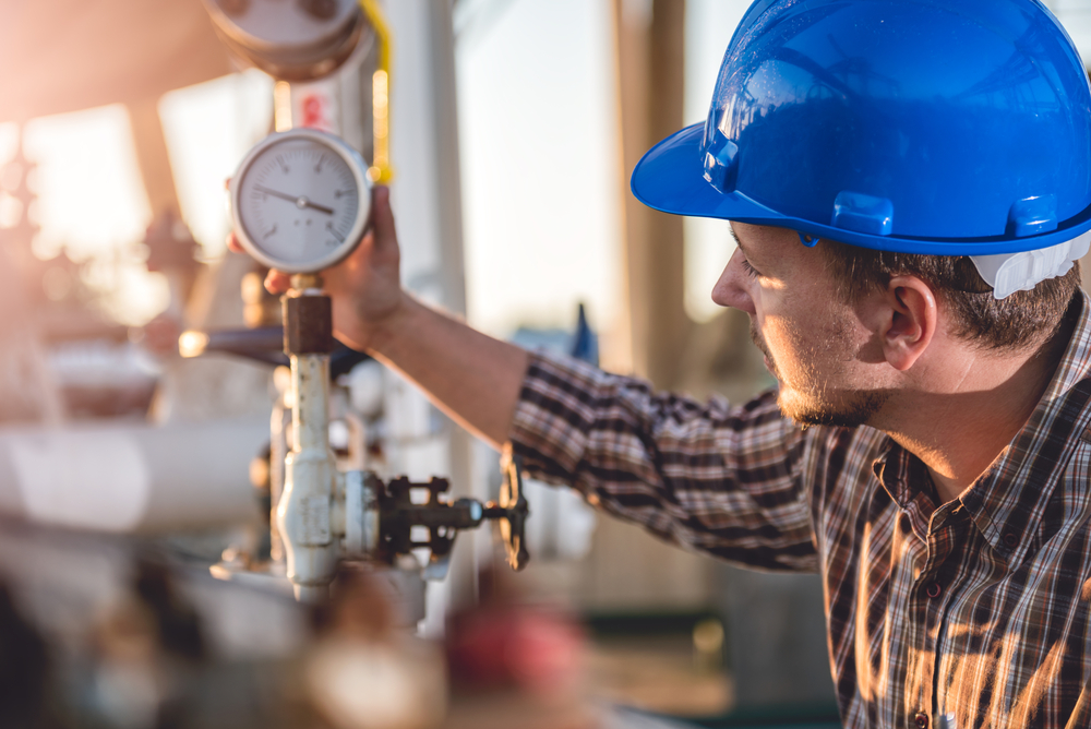 Figure 19: Visual inspector taking a pressure gauge reading.